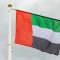UAE flag in the sky with white clouds